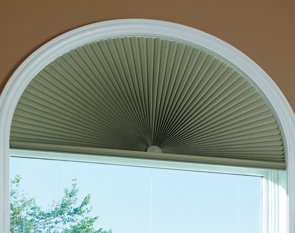 Hunter Douglas Duette honeycomb shades in soft green add a pop of color and visual interest to the window. 